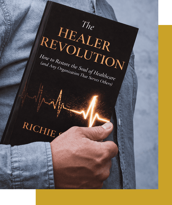 Person holding the book 'The Healer Revolution' by Richie Norton.